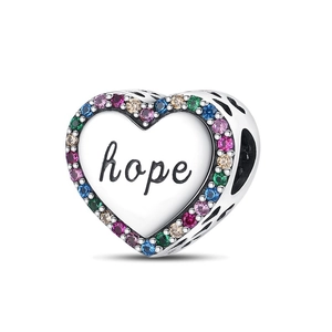 Macro detail of silver heart charm with hope engraving and colorful zircon stones