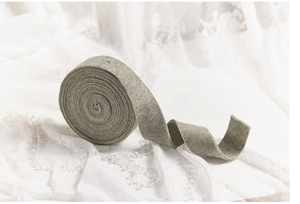 Detailed view of thick grey wool felt ribbon roll for DIY Christmas handmade crafts