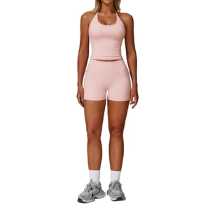 Pink halter neck yoga set featuring high waisted compression shorts for fitness