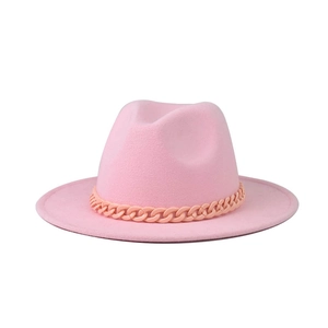 Detailed view of pink fedora hat featuring a stylish matte pink chain link decoration