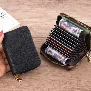 Detail of lychee textured leather accordion card wallet with gold zipper and multi-slots