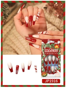 Close-up of Christmas press-on nails with snowflakes and red candy cane patterns