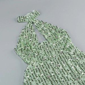 Detail of mint green mesh dress featuring shimmering sequins and rhinestone accents