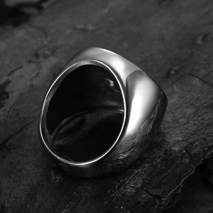 Polished silver stainless steel Viking Tree of Life ring for men on dark rock surface