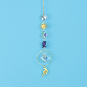 Detail of golden suncatcher with purple stones, crystal ball and crescent moon fairy pendant