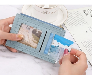 Slim blue leather wallet with multi-card slots and photo ID window in lifestyle scene