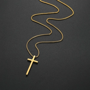 Minimalist gold cross pendant necklace for men with sleek box chain on black background