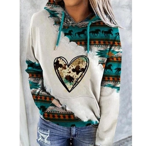 Detail of vintage patterned women's hoodie with cow-print heart and horse silhouette print