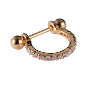 Close-up of gold cartilage stud with leaf pattern and sparkling cubic zirconia stones