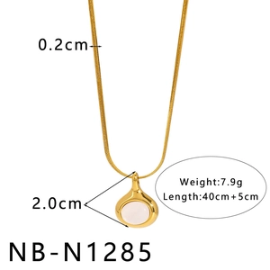 Detailed view of 18K gold plated snake chain with a 2cm round white pendant