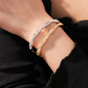 Close-up of gold and silver quilted textured bangles set with sparkling cubic zirconia