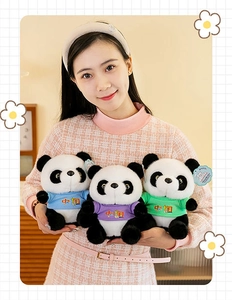 Detailed view of three adorable panda plush toys in colorful t-shirts held by a model.