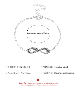 Macro detail of silver snake infinity charm with technical product specifications