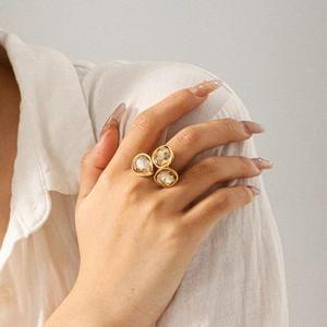 Detailed side view of 18k gold stainless steel ring featuring three amber crystal stones