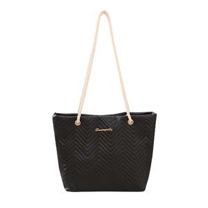 Minimalist black tote bag with zigzag quilting and braided rope handles for daily use