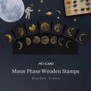 7-piece lunar phase wooden stamp set with gold foil detailing for DIY journaling
