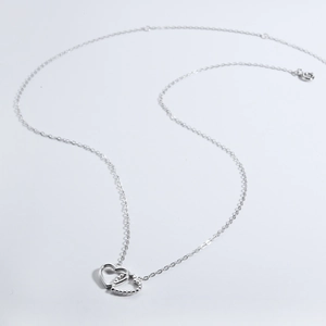 Detailed close-up of double interlocking heart pendant in S925 silver finish necklace