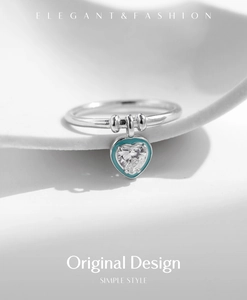 Close-up of S925 silver ring featuring heart pendant with mint green enamel and crystal