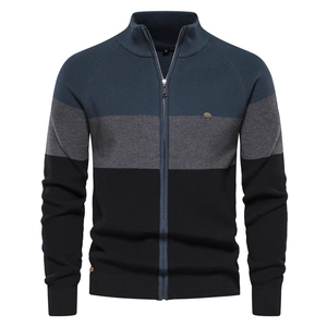 Detail of men's color-block knit cardigan with stand collar and metal logo badge