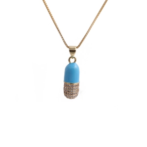 Close-up of a gold capsule pendant with light blue enamel and micro-pave zircons