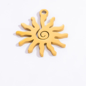 Macro view of sun-shaped 18k gold plated stainless steel pendant with spiral pattern
