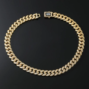 Close-up of gold iced-out Cuban link chain with a diamond-encrusted dollar sign clasp