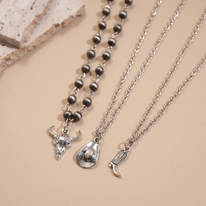 Three-piece retro western necklace set featuring buffalo skull, cowboy hat, and boot charms