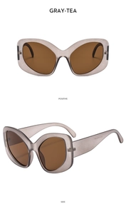 Detail view of large gray-tea cat eye sunglasses showing front and side profile
