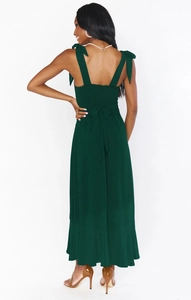 Detail of dark green dress showing bow-tie straps and elastic shirred back design