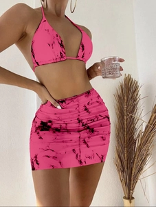 Detail of pink marble print bikini top and matching mesh skirt with vibrant pattern