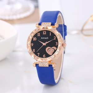 Detail of rose gold watch with sparkling rhinestones and dark blue leather strap