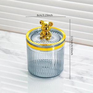 Detail of gray striped storage jar with golden bear lid and dimensions 8x12.5cm