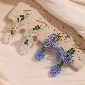 Detail of handmade beaded earrings in grape cluster design with 18K gold plated hooks