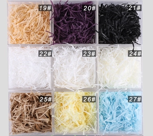 Macro shot of 9 colorful shredded paper raffia filler colors for gift box packaging