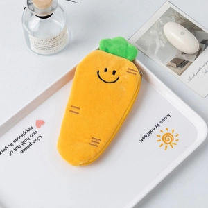 Close-up of bright orange plush carrot pencil case with green leaves and zipper