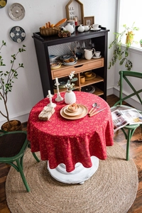 Detail of red Christmas tablecloth with golden snowflake prints on cotton linen fabric