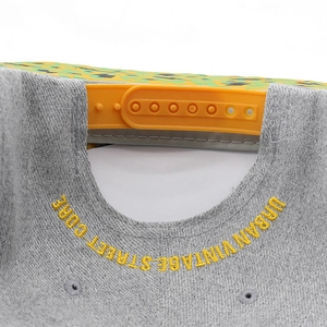 Detail of grey baseball cap showing orange snapback closure and Urban Vintage embroidery