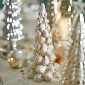 Luminous glass Christmas tree tabletop ornament with warm glowing lights and snowy texture