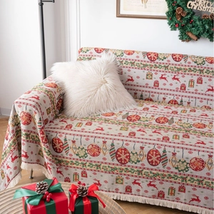 Festive Christmas sofa cover with red reindeer motifs and elegant white tassels