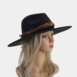 Detail of wide brim felt fedora hat featuring ethnic beaded rope and tassel decoration