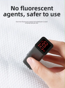 Handheld fluorescent agent tester showing zero reading on thick white cotton towel