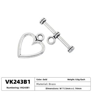 Detail of a vintage heart-shaped brass toggle clasp with textured finish for DIY jewelry