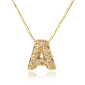 Detailed view of a gold letter A pendant necklace with sparkling cubic zirconia pavé