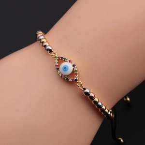 Close-up of adjustable Evil Eye bracelet with blue zircon beads on female wrist