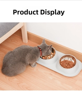 Detail showing an elevated grey stand with dual stainless steel bowls for pet neck protection