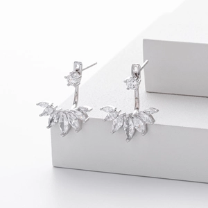 Detail of silver ear jackets with marquise and round cubic zirconia on white blocks
