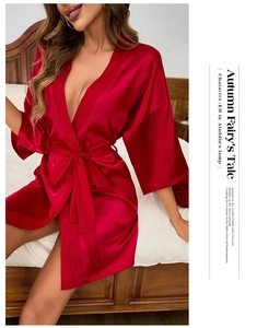 Detail of red satin robe featuring tie-waist with elegant tassel fringe accents