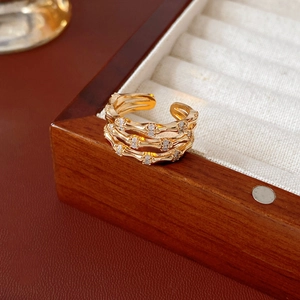 Macro shot of gold bamboo joint ring with zircon pave detail on jewelry box