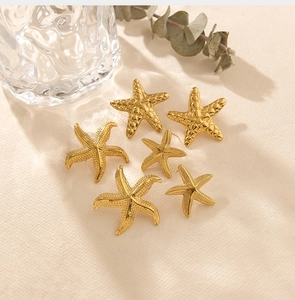 Détails des boucles d'oreilles étoile de mer dorées avec textures mates et martelées