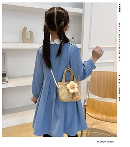 Girl's straw crossbody bag with floral decoration and pompom detail on model